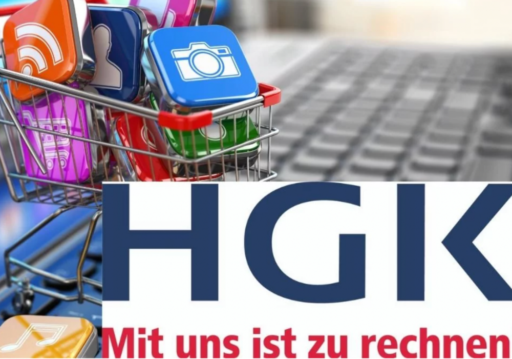 Einkaufswagen mit buntem Inhalt und HGK Logo